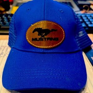 Snap back baseball cap with a custom leather patch that says Mustang.